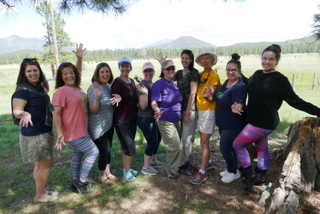 Group of girl scout leaders with meadow and mountain in the background
